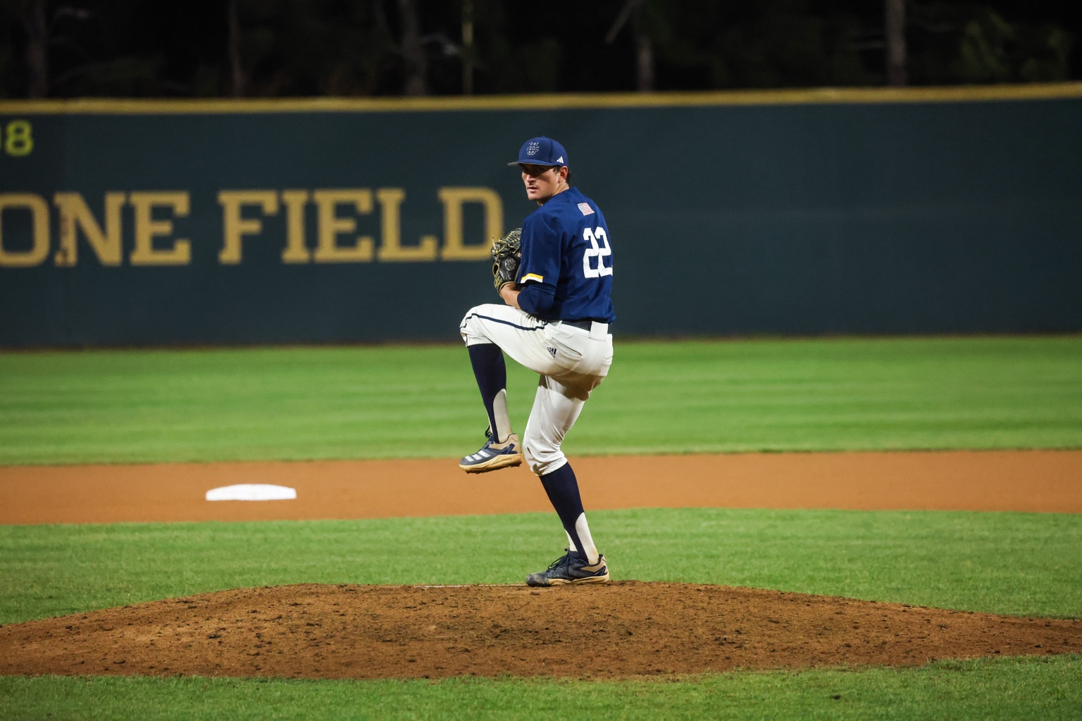 Coach David pitching in a college baseball game